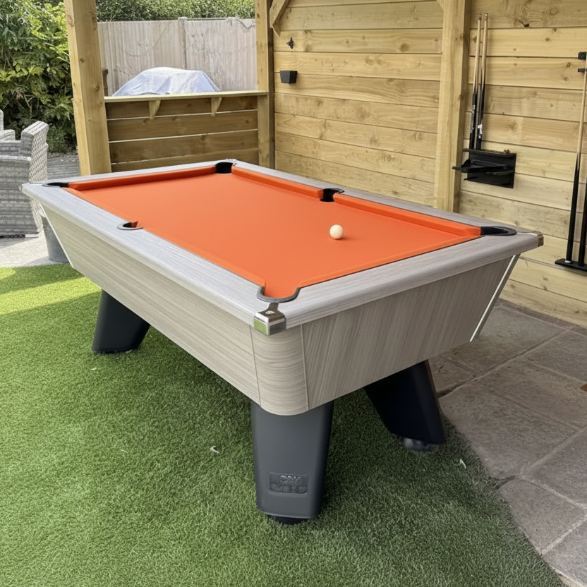 Pool table with orange felt in an outdoor s