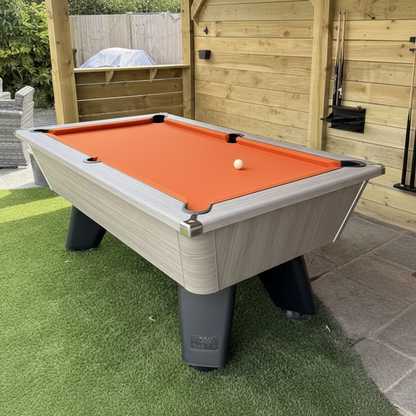 Pool table with orange felt in an outdoor s